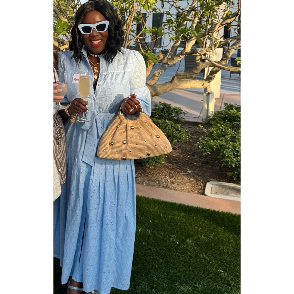 Airy eyelets shirtdress with a defining sash and framed by abbreviated sleeves
